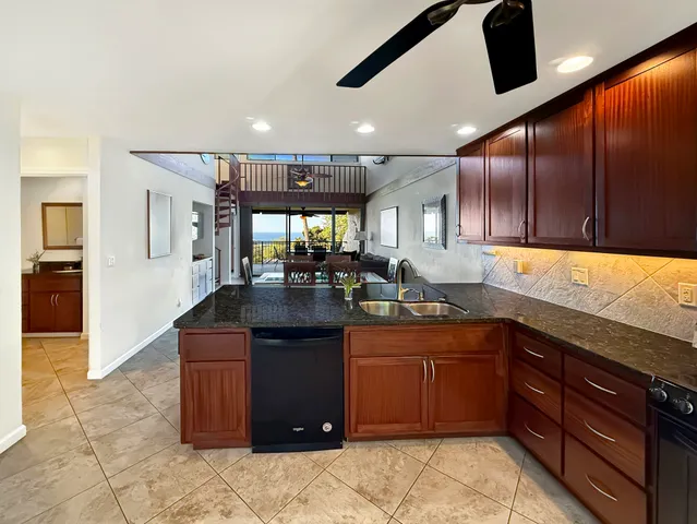 a kitchen with stainless steel appliances granite countertop wooden cabinets a sink and dishwasher