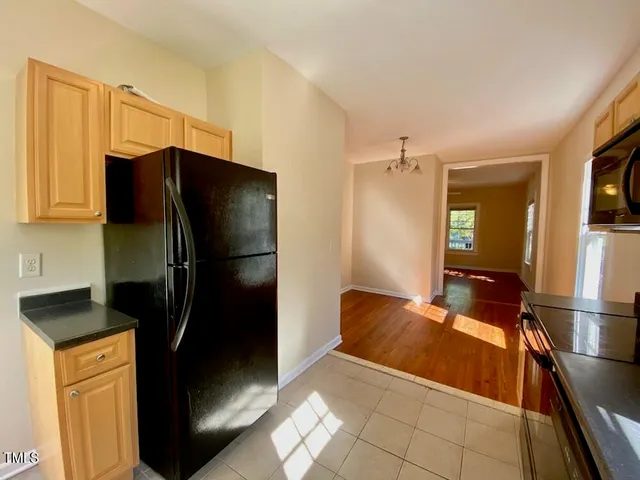 a kitchen with a refrigerator and a sink