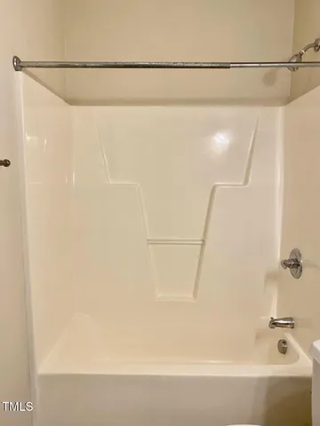 a bathroom with a shower and a bathtub