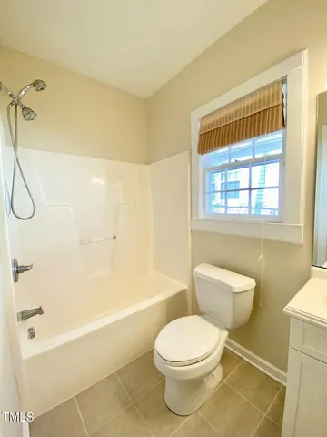 a bathroom with a toilet a sink and shower