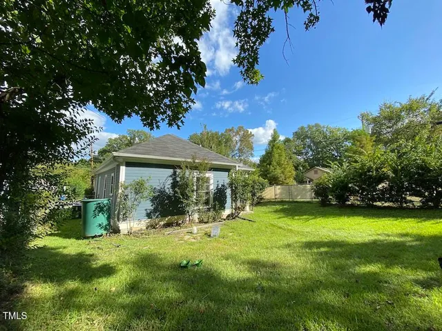 a backyard of a house with yard and outdoor seating