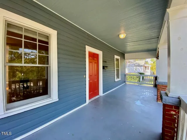 a view of a room with wooden floor and windows