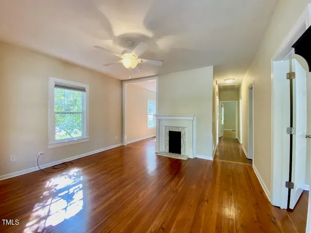 a view of empty room with wooden floor