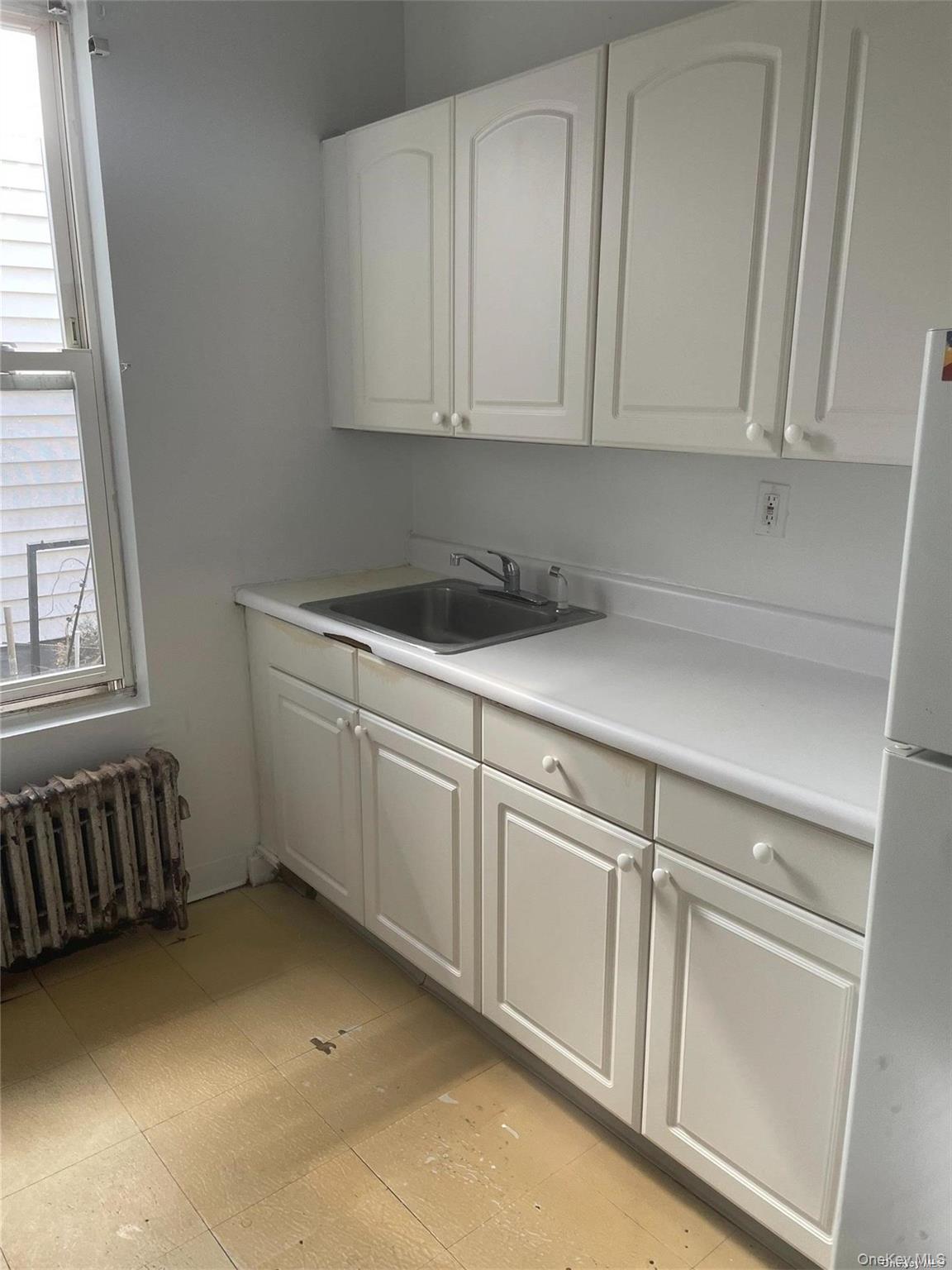 62 Middle Neck Road, Unit 2REAR Great Neck, NY 11021 - Photo 5 of 9 a kitchen with white cabinets