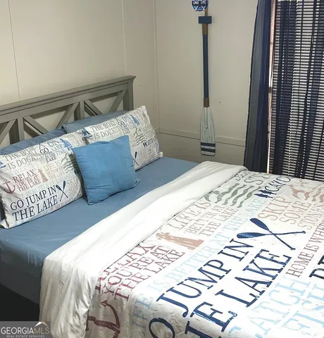 a bedroom with a bed and a rug