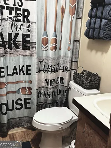 a bathroom with a toilet sink and mirror