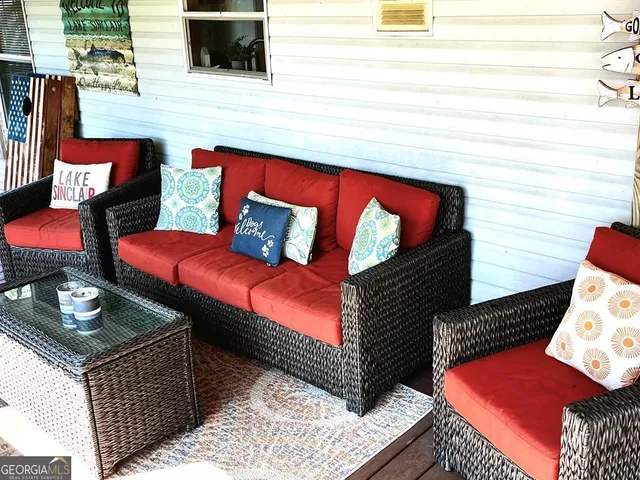 a outdoor sitting area with furniture and a flat screen tv