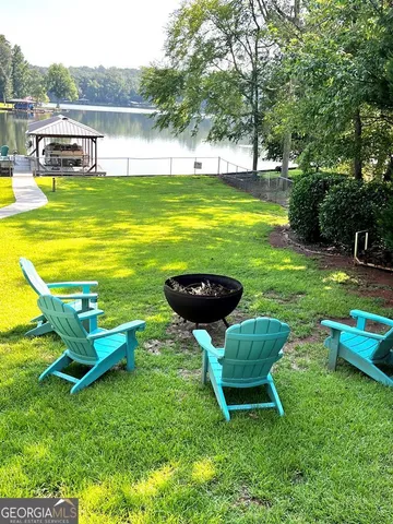 a view of a swimming pool with a garden and deck