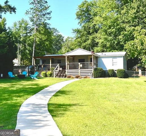 a front view of a house with a yard table and chairs