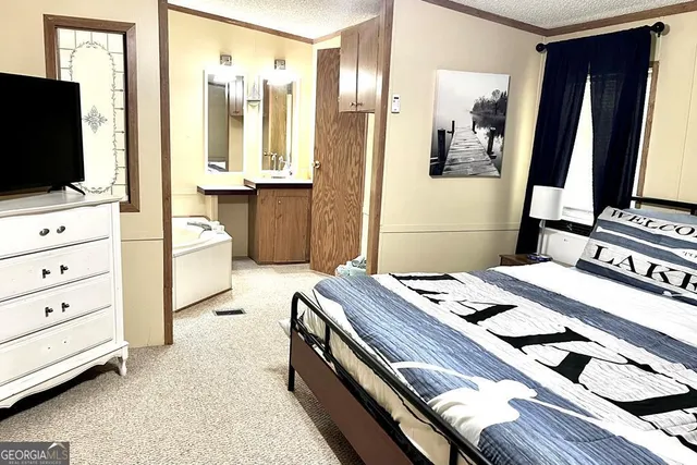 a bedroom with a bed and a flat tv screen