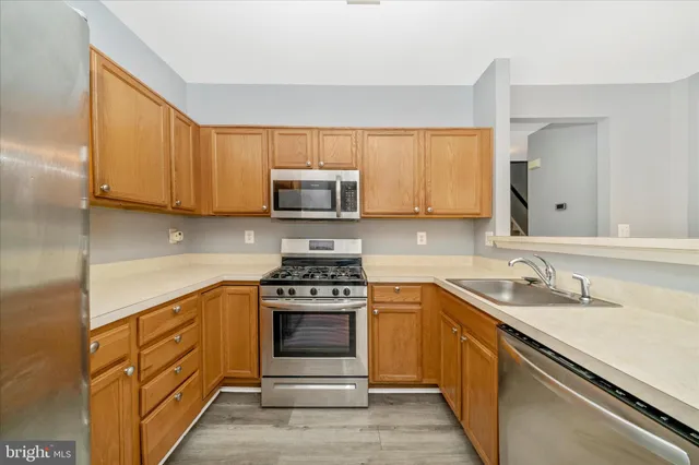 a kitchen with stainless steel appliances granite countertop a sink stove and microwave