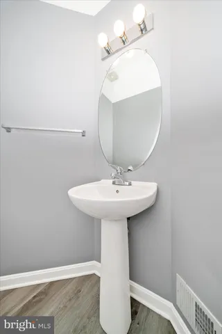 a bathroom with a sink a mirror and vanity