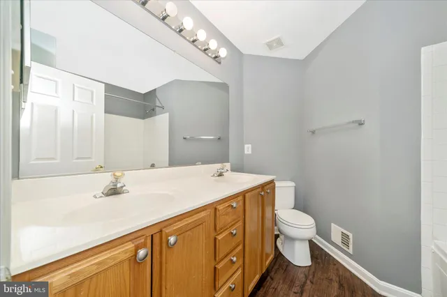 a front view of a building with parking area