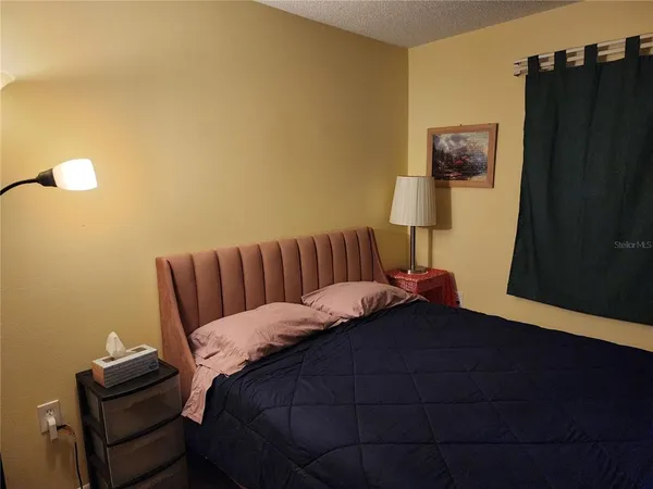 a bed sitting in a bedroom next to a bathroom