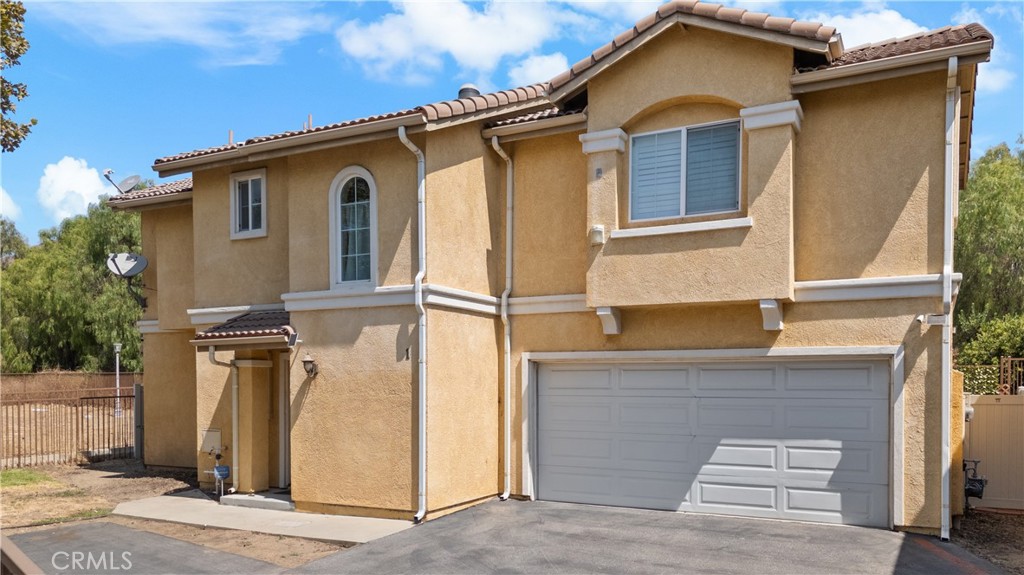 15151 Foothill Boulevard, Unit 1 Sylmar, CA 91342 - Photo 1 of 1 a front view of a house with a garage