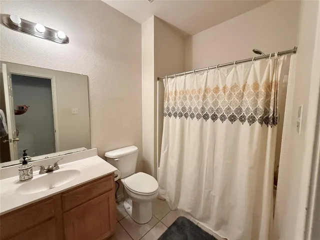 a bathroom with a toilet a sink and a mirror