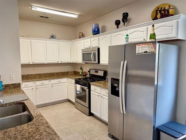 a kitchen with a refrigerator sink and stove