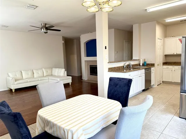 a kitchen with a table chairs and wooden floor