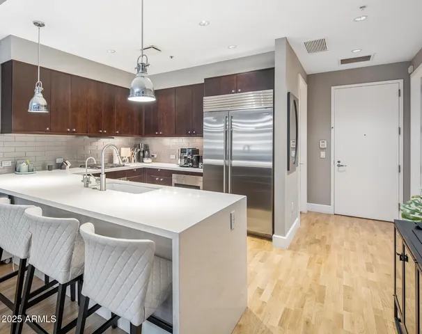 a kitchen with kitchen island a sink stove and refrigerator