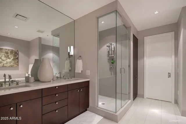 a bathroom with a shower sink and mirror