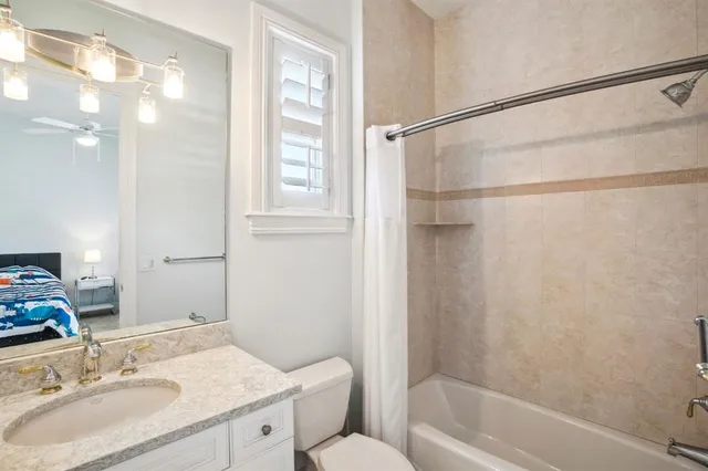 a spacious bedroom with a bed and a window