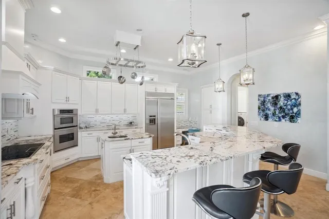 a kitchen with kitchen island granite countertop a sink and stove