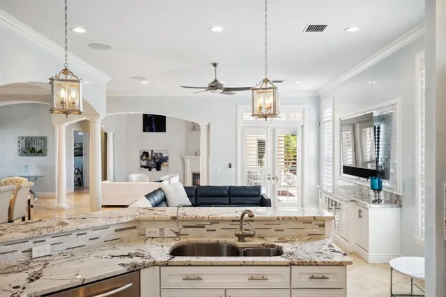 a living room with stainless steel appliances kitchen island granite countertop furniture and a view of living room
