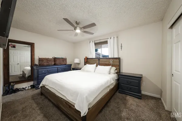 a bedroom with bed and a chandelier