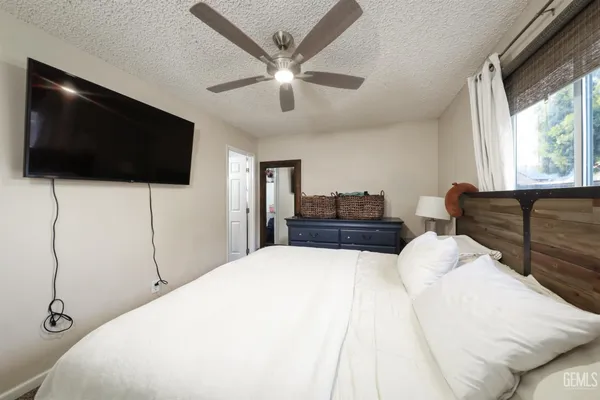 a bedroom with a large bed and a flat screen tv