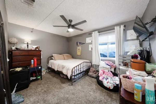 a bedroom with bed and a large window