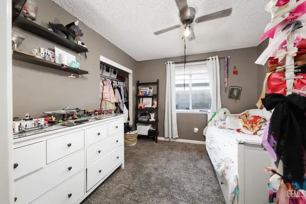 a bedroom with a baby bed baby crib and a window