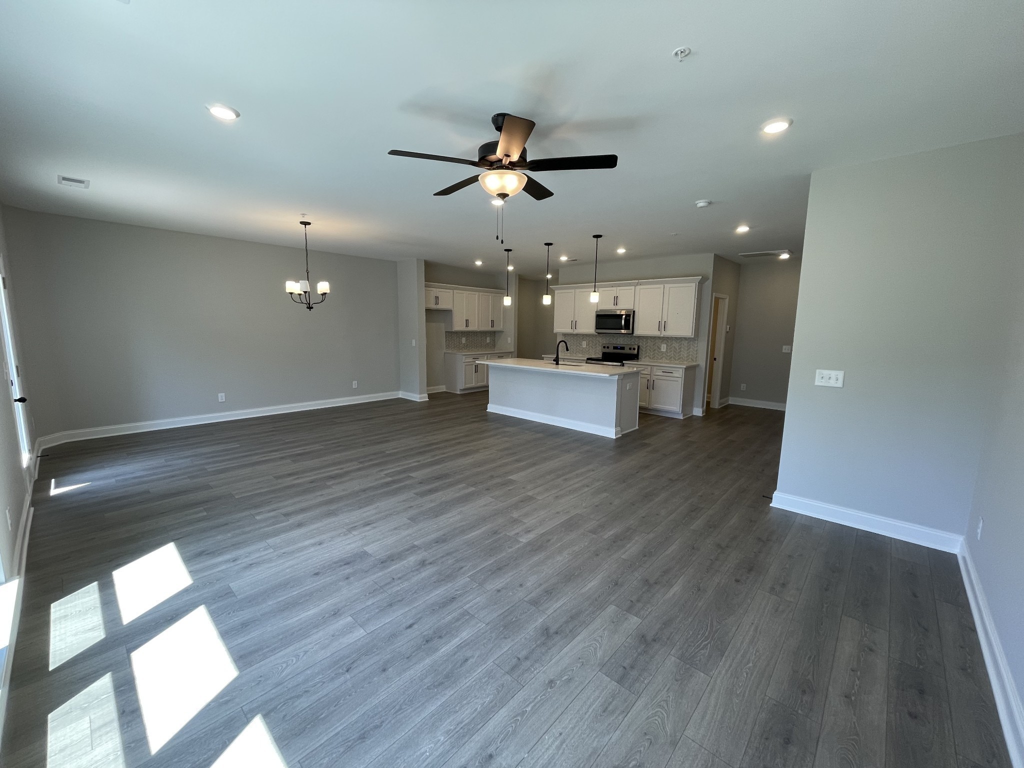1154 June Wilde Ridge Spring Hill, TN 37174 - Photo 7 of 37 a view of a kitchen with a sink and wooden floor