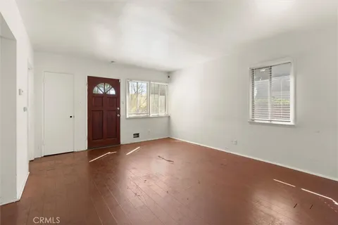 an empty room with windows and closet