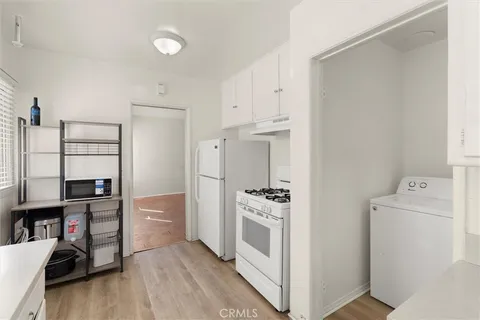 a kitchen with stainless steel appliances a stove a refrigerator and cabinets