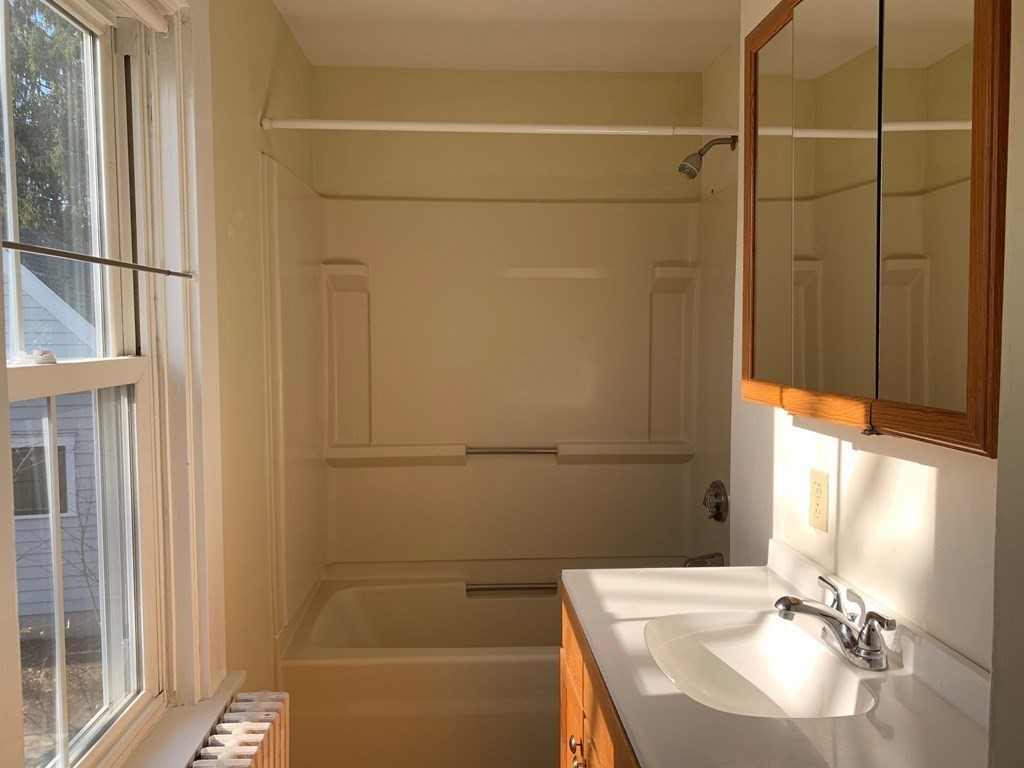 5 Plain Street Natick, MA 01760 - Photo 15 of 31 a bathroom with a sink and a mirror