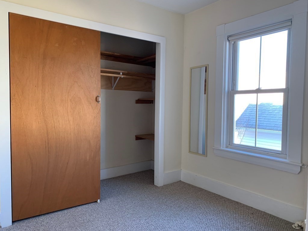5 Plain Street Natick, MA 01760 - Photo 17 of 31 a view of an empty room with a window