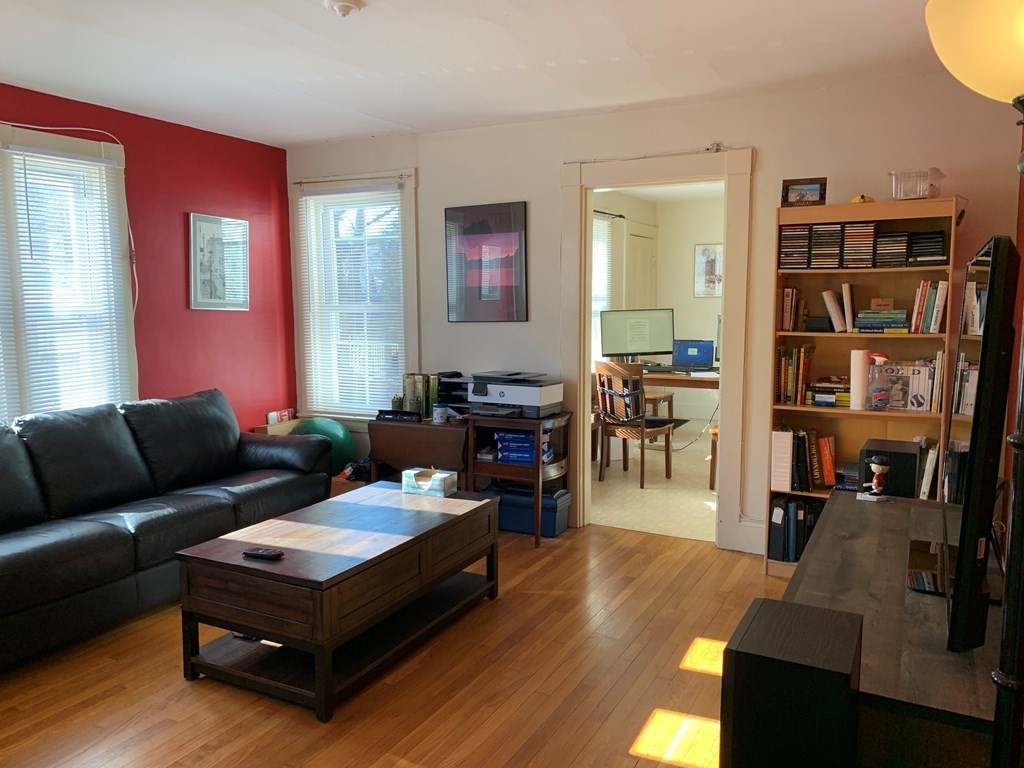 5 Plain Street Natick, MA 01760 - Photo 20 of 31 a living room with furniture and a book shelf