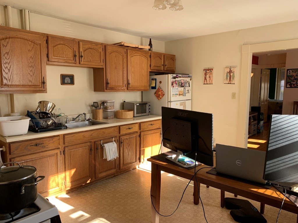 5 Plain Street Natick, MA 01760 - Photo 22 of 31 a kitchen with stainless steel appliances a stove a sink and a refrigerator