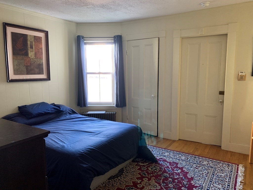 5 Plain Street Natick, MA 01760 - Photo 27 of 31 a bedroom with a bed and a window