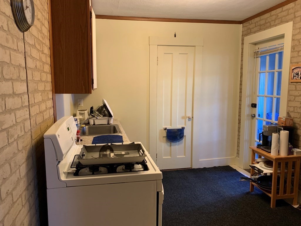 5 Plain Street Natick, MA 01760 - Photo 28 of 31 a view of storage and utility room with wooden floor
