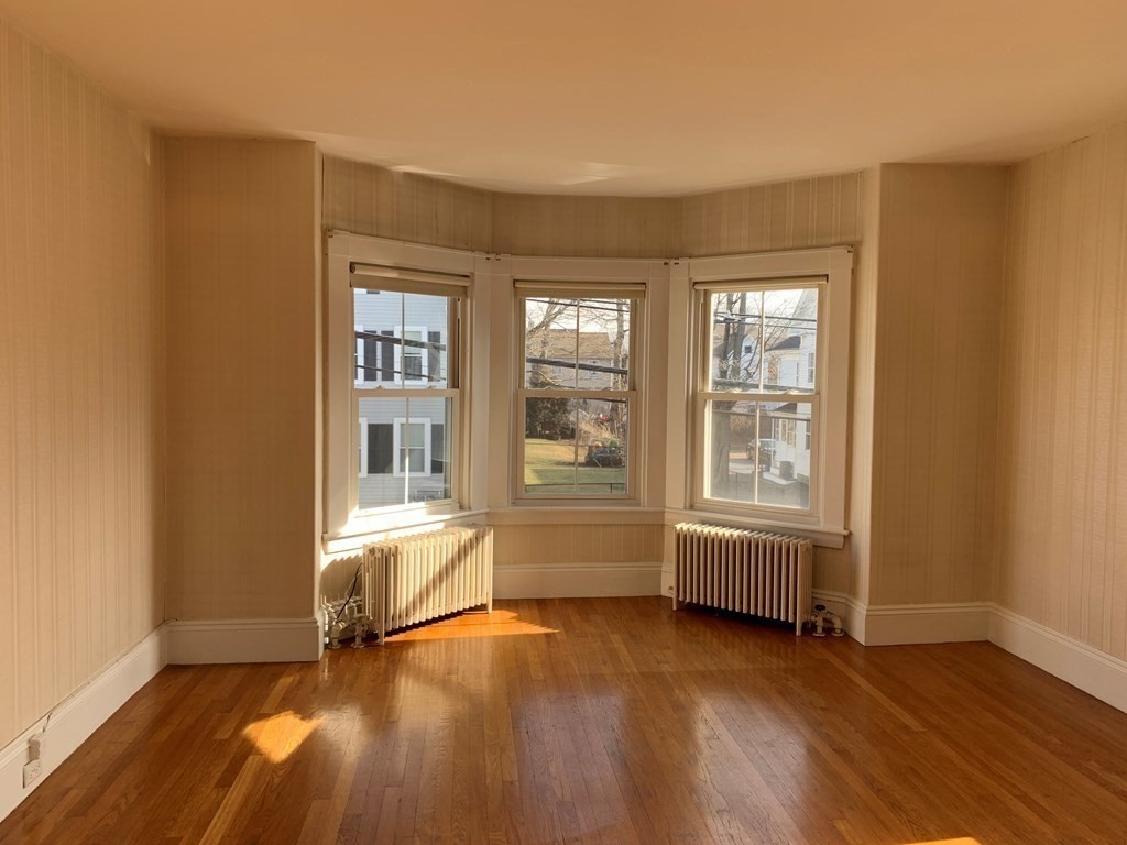 5 Plain Street Natick, MA 01760 - Photo 5 of 31 an empty room with wooden floor and windows