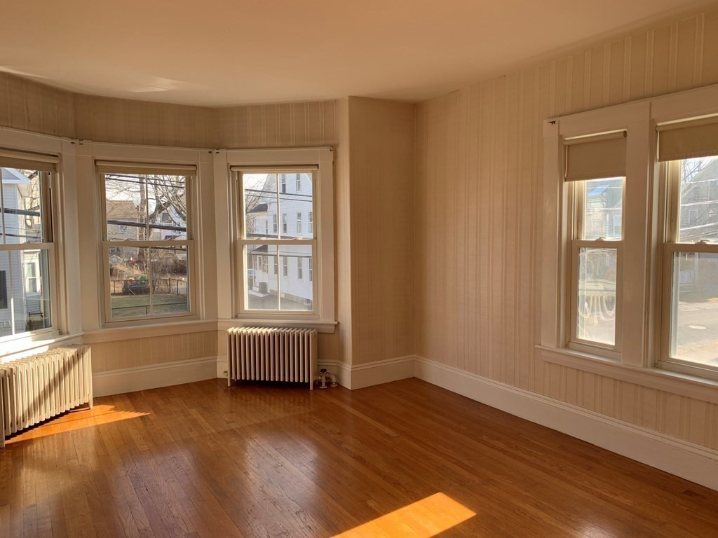 5 Plain Street Natick, MA 01760 - Photo 6 of 31 an empty room with wooden floor and windows