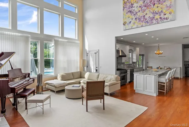 a living room with furniture wooden floor and a large window