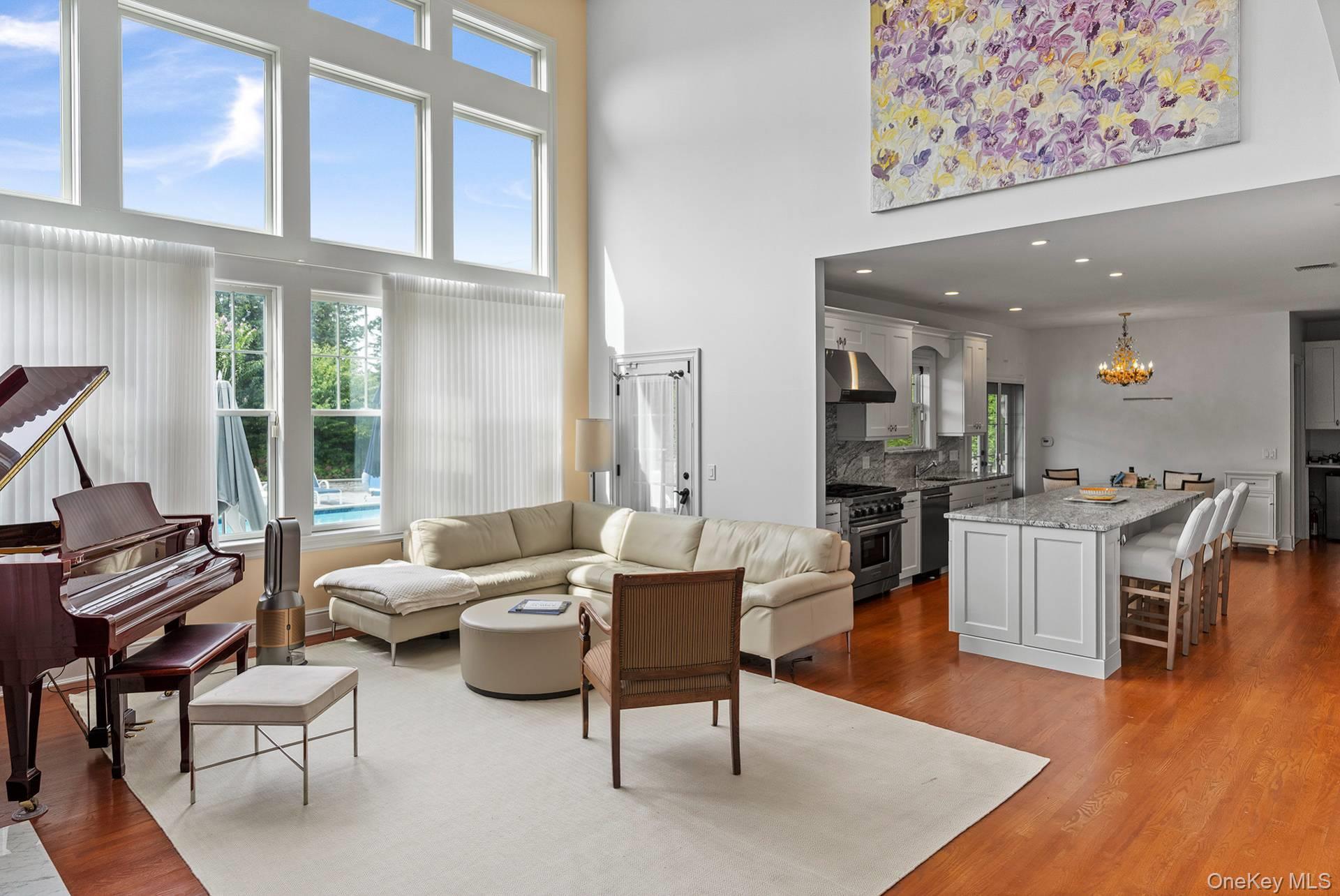 4 Spring Lane Southampton, NY 11968 - Photo 12 of 39 a living room with furniture wooden floor and a large window