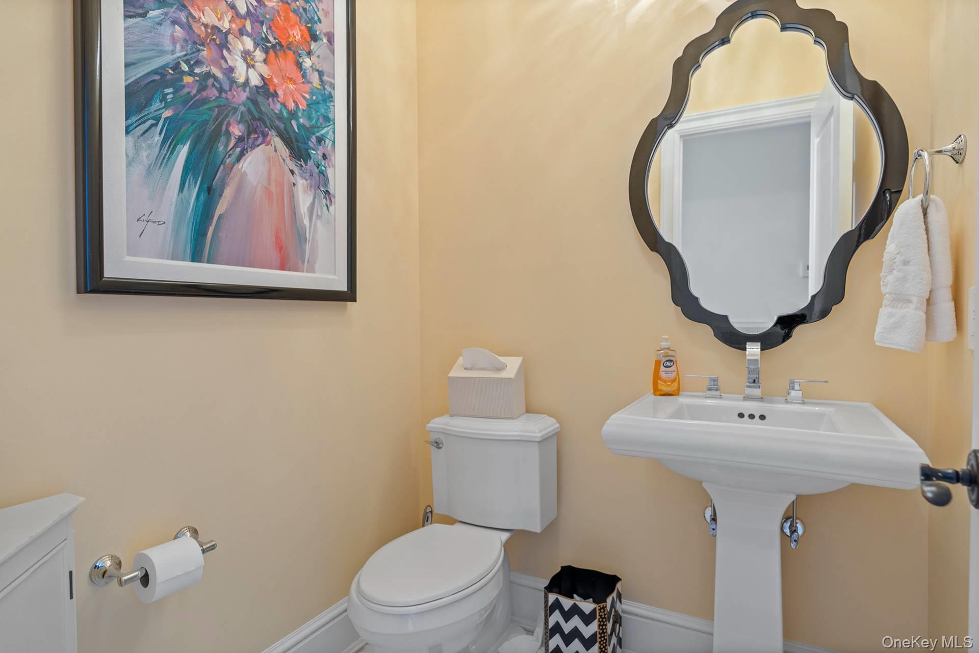 4 Spring Lane Southampton, NY 11968 - Photo 16 of 39 a bathroom with a toilet sink and mirror