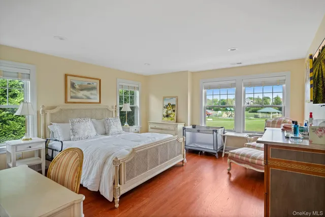 a bedroom with a large bed and a large window