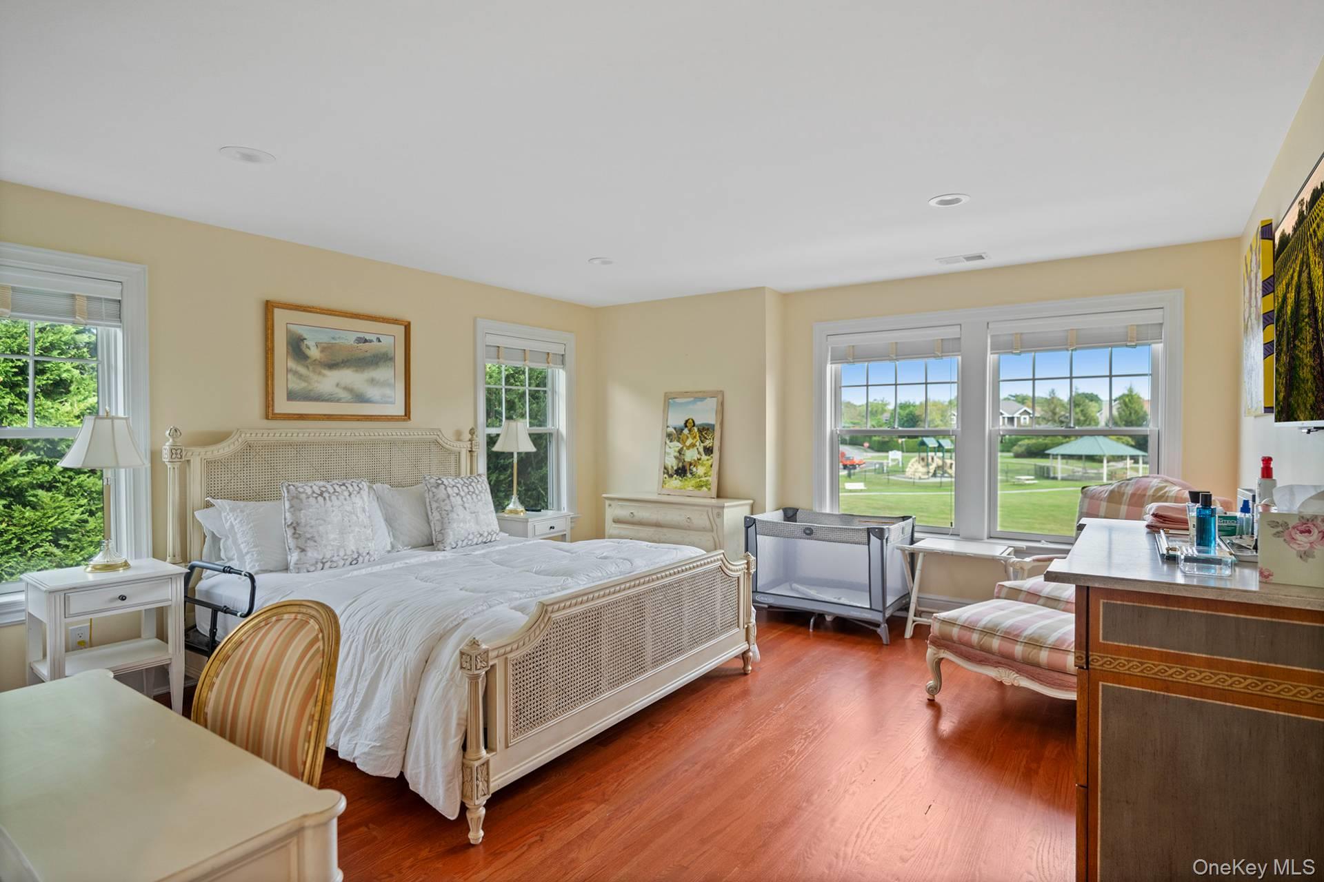 4 Spring Lane Southampton, NY 11968 - Photo 18 of 39 a bedroom with a large bed and a large window