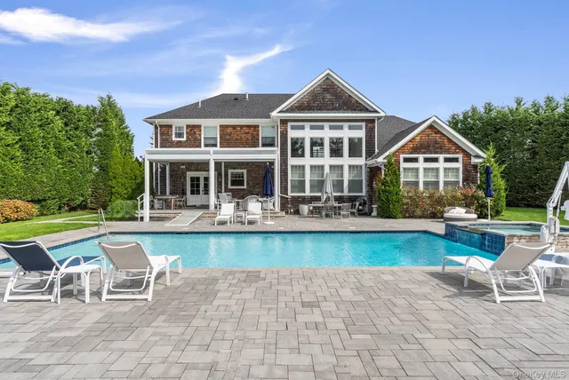 a front view of a house with a yard table and chairs