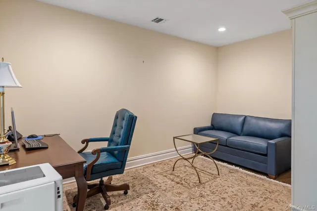 a work room with furniture and a wooden floor