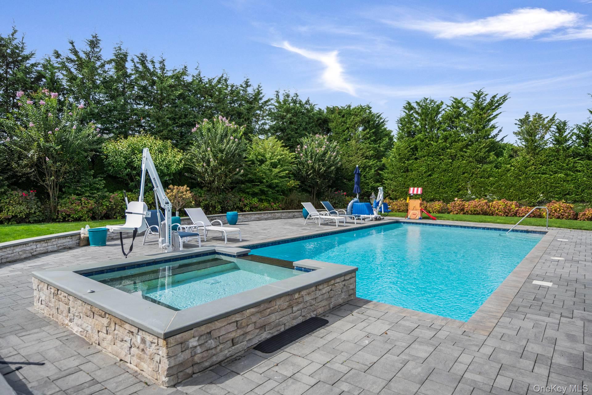 4 Spring Lane Southampton, NY 11968 - Photo 30 of 39 a view of a swimming pool with a patio and a yard